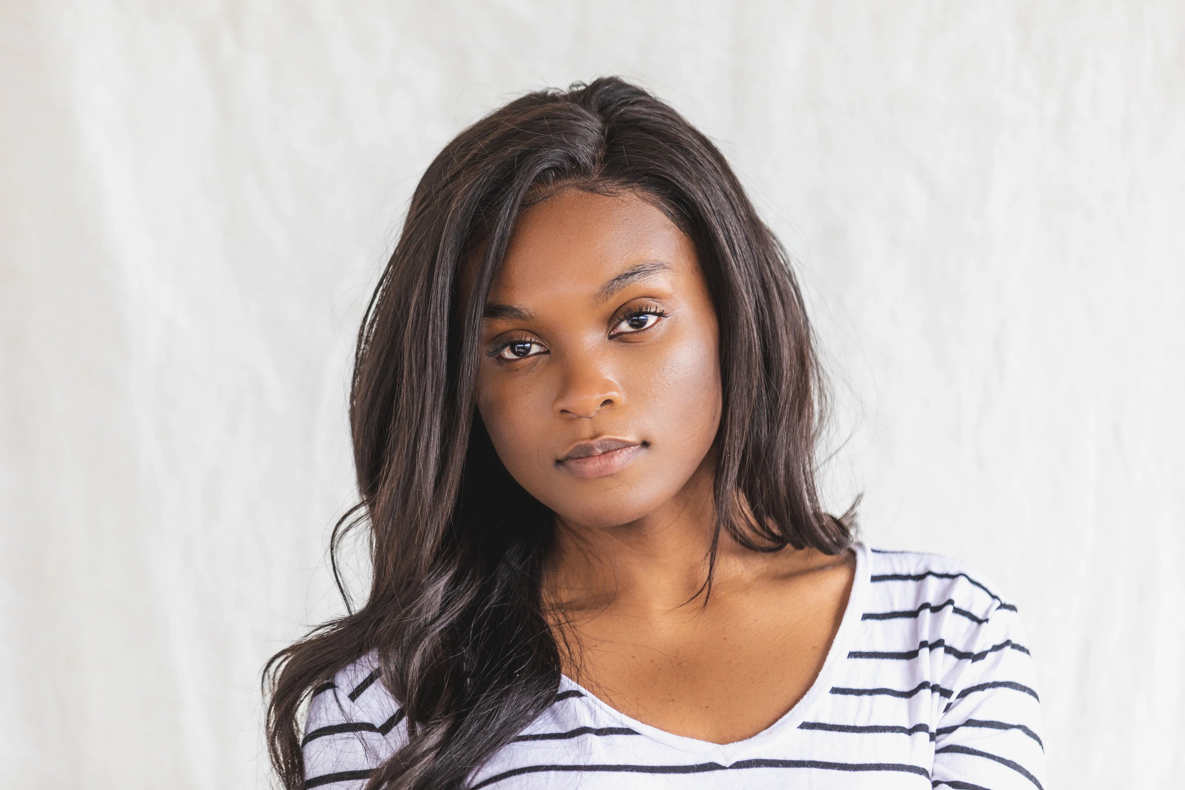 files/a-young-woman-posing-in-a-black-and-white-shirt.webp